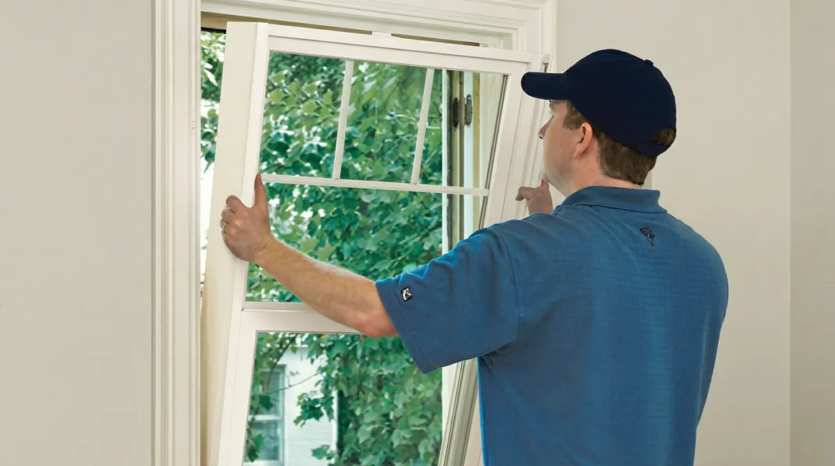 Professional contractors performing a residential window insulation and replacement service in Bloomington, IN
